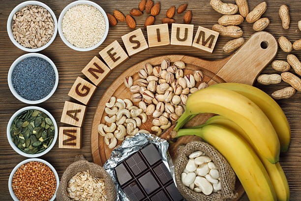 Magnesium spelled with letter blocks surrounded by various foods