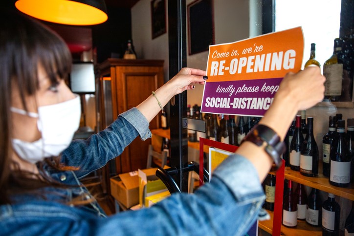 Employee putting up re-opening sign