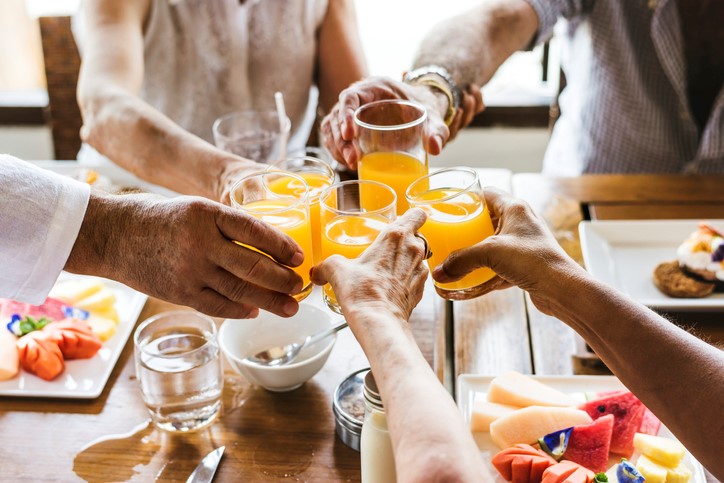 group of people with orange juice